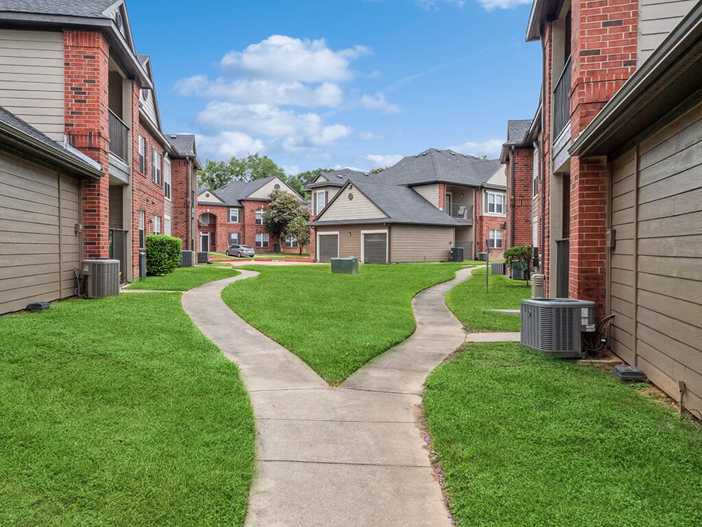 Walkway in between buildings at Hollow Creek Apartments in Conroe TX